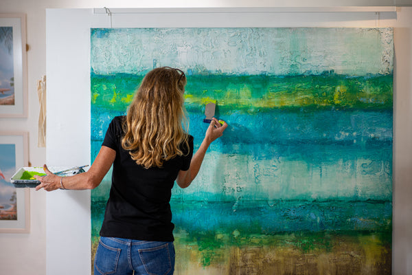 Artist painting blue and green abstract artwork - Studio 2 Art & Design