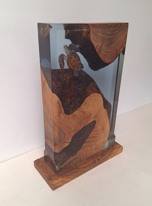 Decorative resin sculpture with a turtle on a wooden base and background