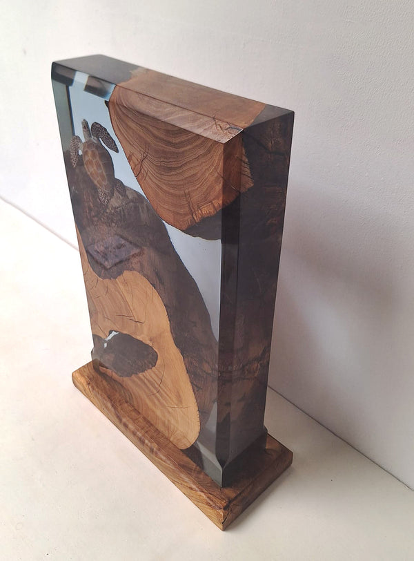 Decorative resin sculpture with a turtle on a wooden base and background